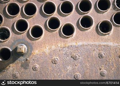 Close-up of rivets and holes on a metal surface
