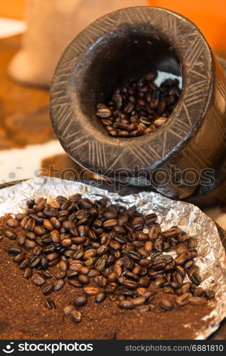Close up of Roasted Coffee Beans and Wooden Coffee Grinder