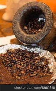 Close up of Roasted Coffee Beans and Wooden Coffee Grinder
