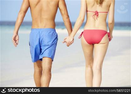 Close Up Of Romantic Couple Walking On Tropical Beach