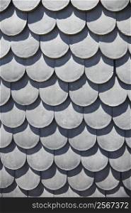 Close-up of rooftop with scale shaped shingles in Lisbon, Portugal.