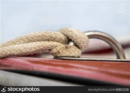 Close up of rope tied up to a knot at the boat.