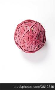 Close-up of rubber band ball over white background