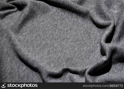 Close-up of rumpled heater and knitted sport jersey or hoodie fabric textured cloth background with delicate striped pattern