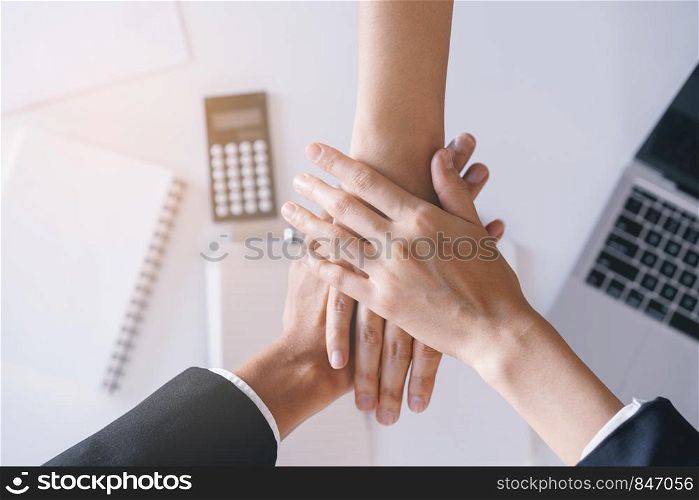 Close-up of salesman shaking hands with lovers who are customers In her office in the house purchase agreement Asian women