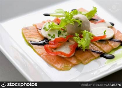 Close-up of salmon dish with palmito and soy sauce