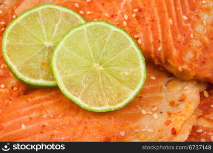close up of salmon with green lemon.