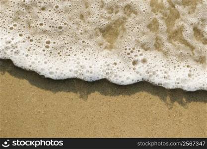 Close-up of sand and wave.