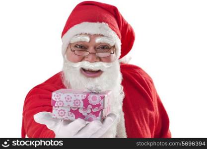 Close up of Santa Claus giving present over white background