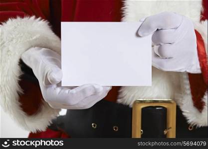 Close Up Of Santa Claus Holding Blank Invitation