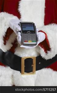 Close Up Of Santa Claus Holding Credit Card Reader