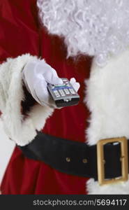 Close Up Of Santa Claus Holding Television Remote Control