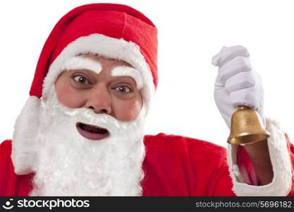 Close up of Santa Claus ringing bell over white background