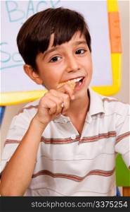 Close-up of school boy enjoying his lunch meal