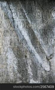 Close-up of script engraved into stone at the Roman Forum in Rome, Italy.