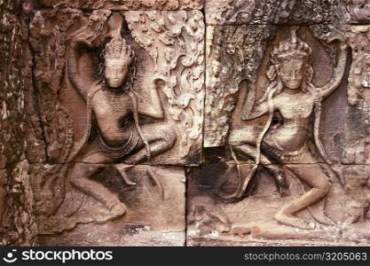 Close-up of sculptures carved on the wall of a temple, Angkor Wat, Siem Reap, Cambodia