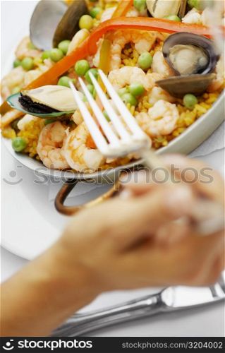 Close-up of seafood with rice and green peas in a pan