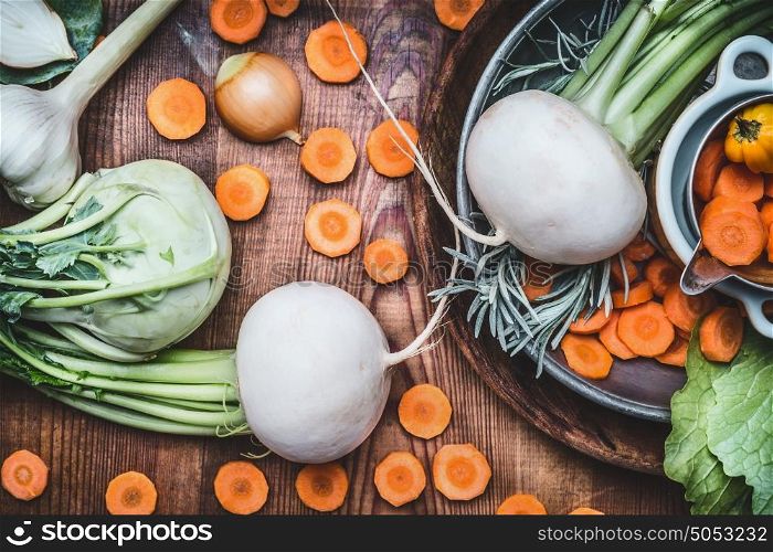 Close up of seasonal organic local vegetables for healthy clean eating and cooking on rustic wooden background, top view, place for text. Vegan or vegetarian food concept