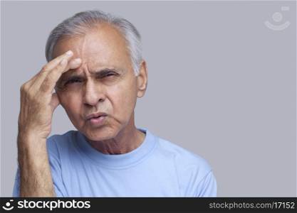Close-up of senior man suffering from headache
