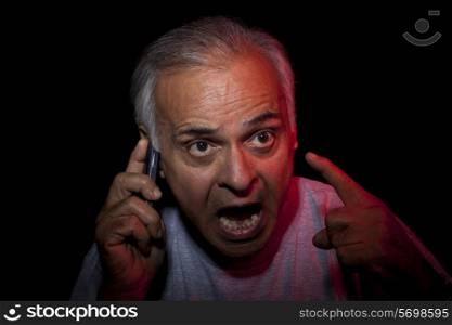 Close-up of senior man talking on cell phone