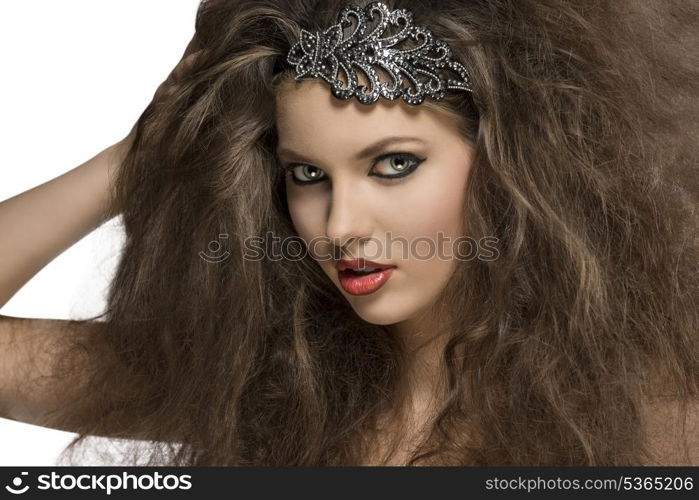 close-up of sensual brunette woman with voluminous curly hair-style, glitter accessory in the hair and strong make-up