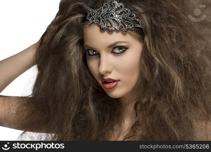 close-up of sensual brunette woman with voluminous curly hair-style, glitter accessory in the hair and strong make-up