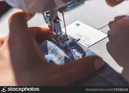 Close up of sewer working with textile and sewing needle