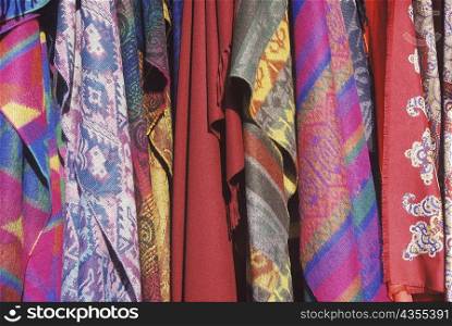 Close-up of shawls hanging in a store
