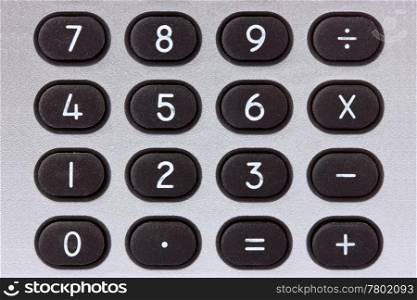 close-up of silver calculator with black buttons