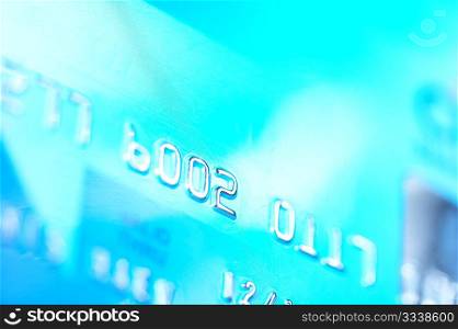 Close-up of silver digits on a blue credit card