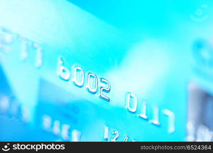 Close-up of silver digits on a blue credit card. Numerical imaginations