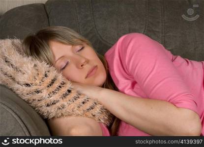 Close up of Sleeping pretty woman at sofa