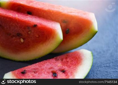 Close up of slice watermelon fruit on dark background - selective focus