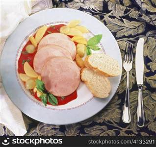 Close-up of sliced ham with sauce in a plate