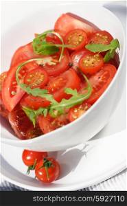 Close - up of sliced tomatoes with rucola