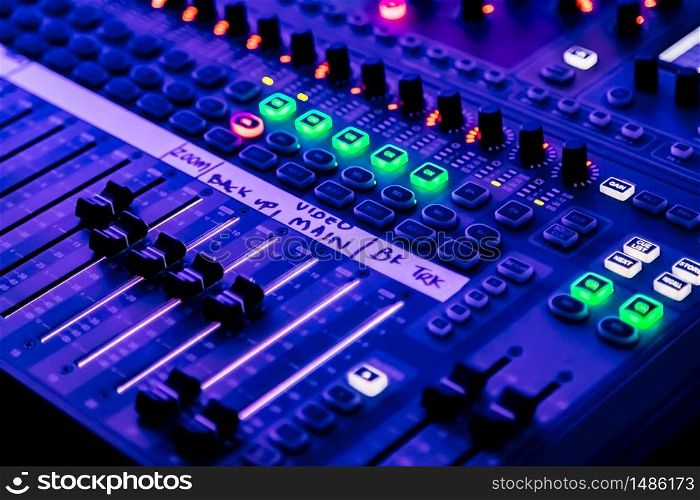Close up of sliders and button on Audio Mixing Desk at live event
