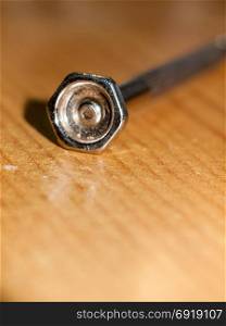 close up of small screw driver nail screw head metal macro; essex; england; uk