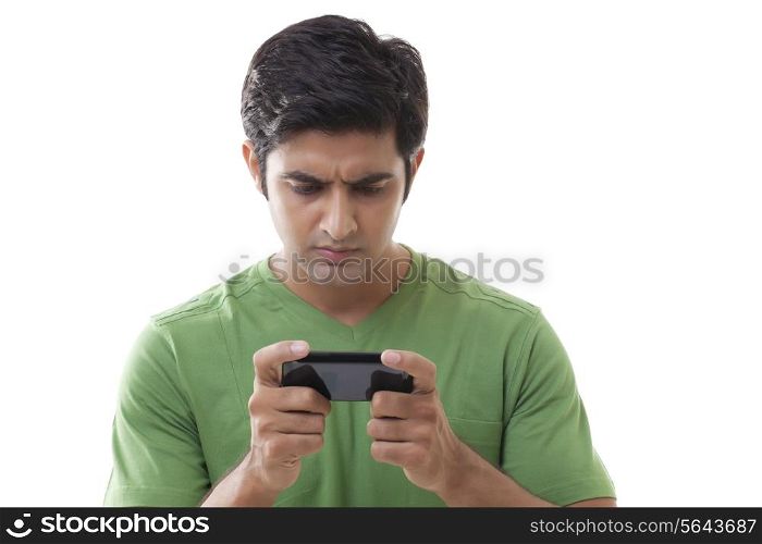 Close-up of smart guy reading text message over white background
