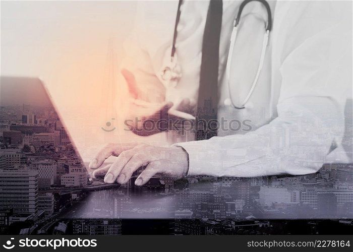close up of smart medical doctor working with digital tablet computer and stylus pen and stethoscope on dark wooden desk with London city exposure