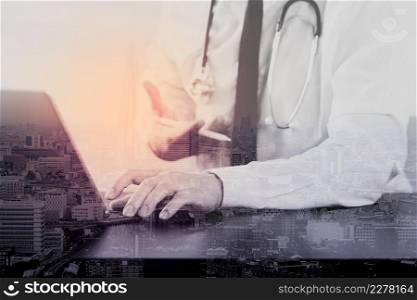 close up of smart medical doctor working with digital tablet computer and stylus pen and stethoscope on dark wooden desk with London city exposure