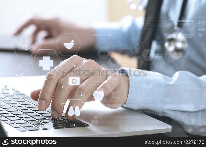 close up of smart medical doctor working with laptop computer and mobile phone and stethoscope on dark wooden desk with virtual reality icon diagram