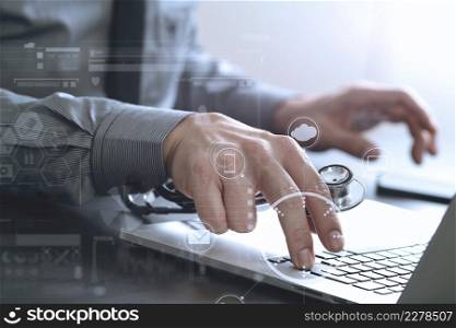 close up of smart medical doctor working with laptop computer and stethoscope on dark wooden desk with virtual reality icon diagram