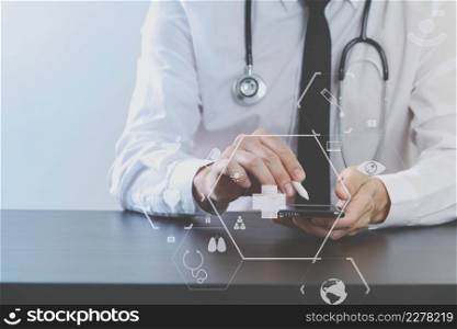 close up of smart medical doctor working with mobile phone and stethoscope on dark wooden desk with virtual icon diagram