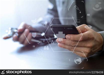 close up of smart medical doctor working with mobile phone and stethoscope on dark wooden desk with virtual reality icon diagram
