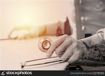 close up of smart medical doctor working with stethoscope and mobile phone on dark wooden desk in modern hospital with London city exposure