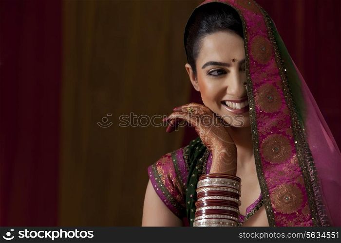 Close-up of smiling beautiful young woman in bridal wear