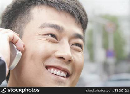 Close Up of Smiling Businessman on the Phone in Beijing