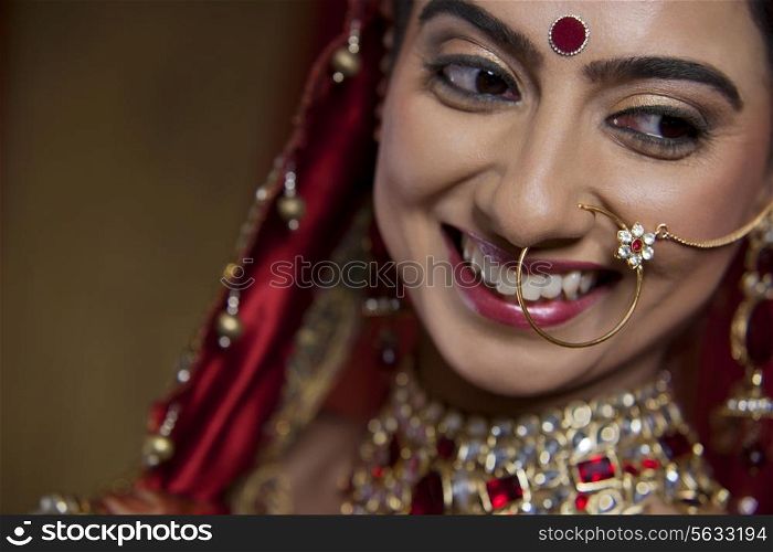 Close up of smiling young bride looking away