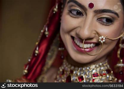 Close up of smiling young bride looking away