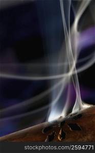 Close-up of smoke rising out of a wooden cylinder